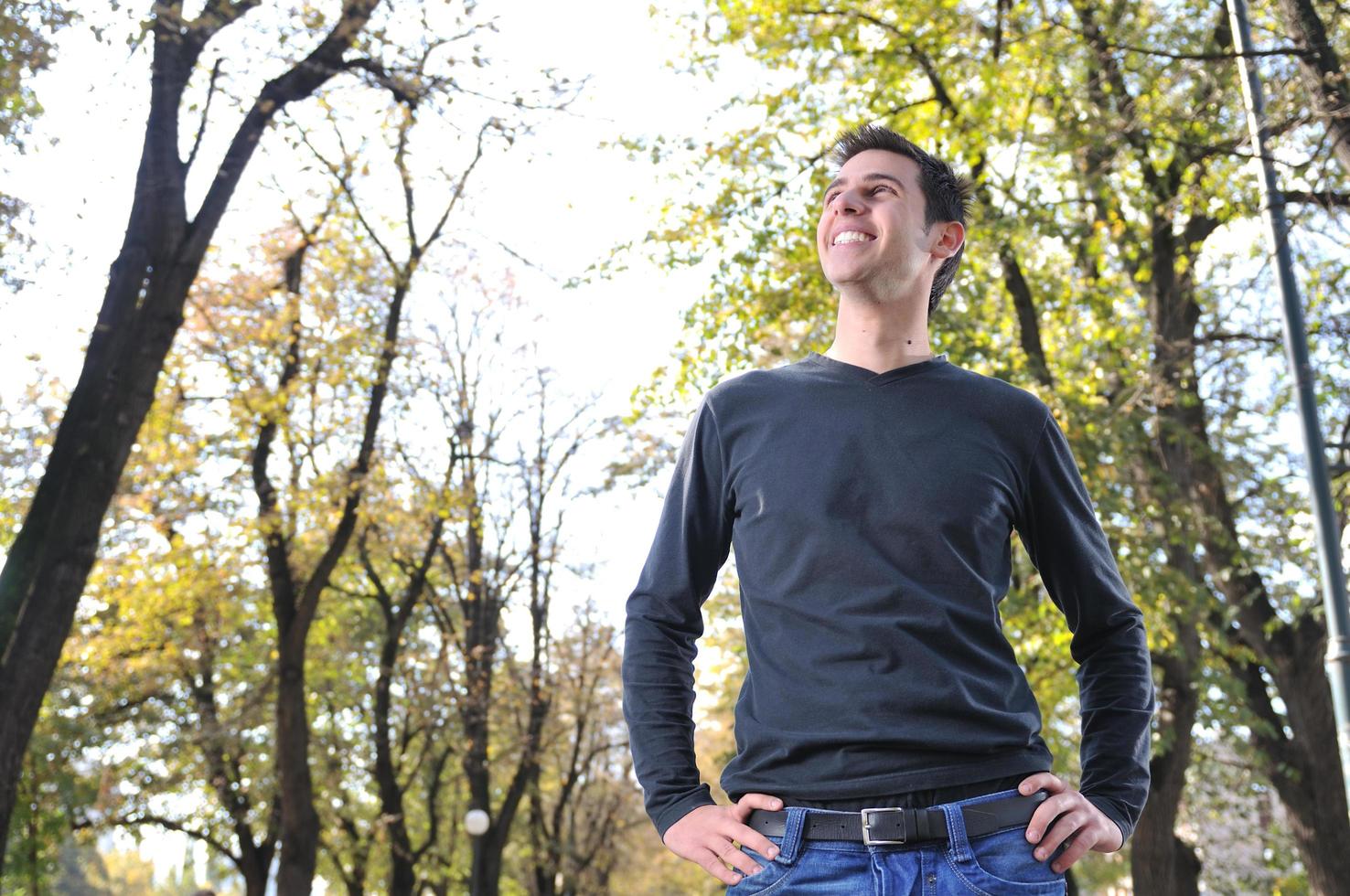 Handsome young man smiling outdoors photo