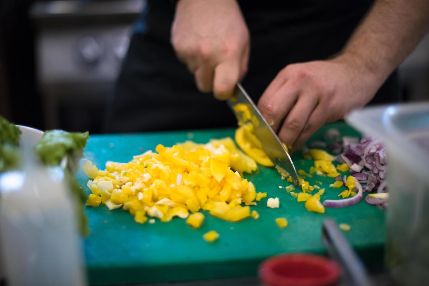 Chef hands cutting fresh and delicious vegetables photo