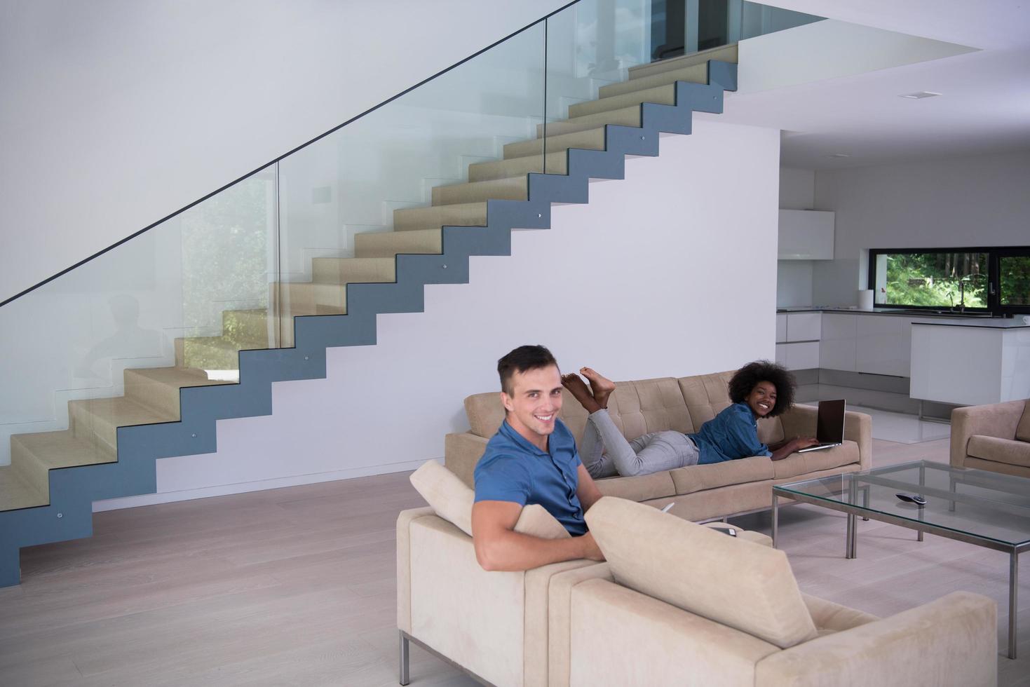 young multiethnic couple relaxes in the living room photo