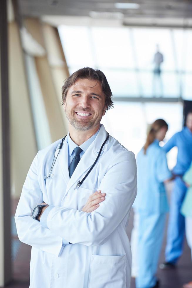 group of medical staff at hospital, handsome doctor in front of team photo