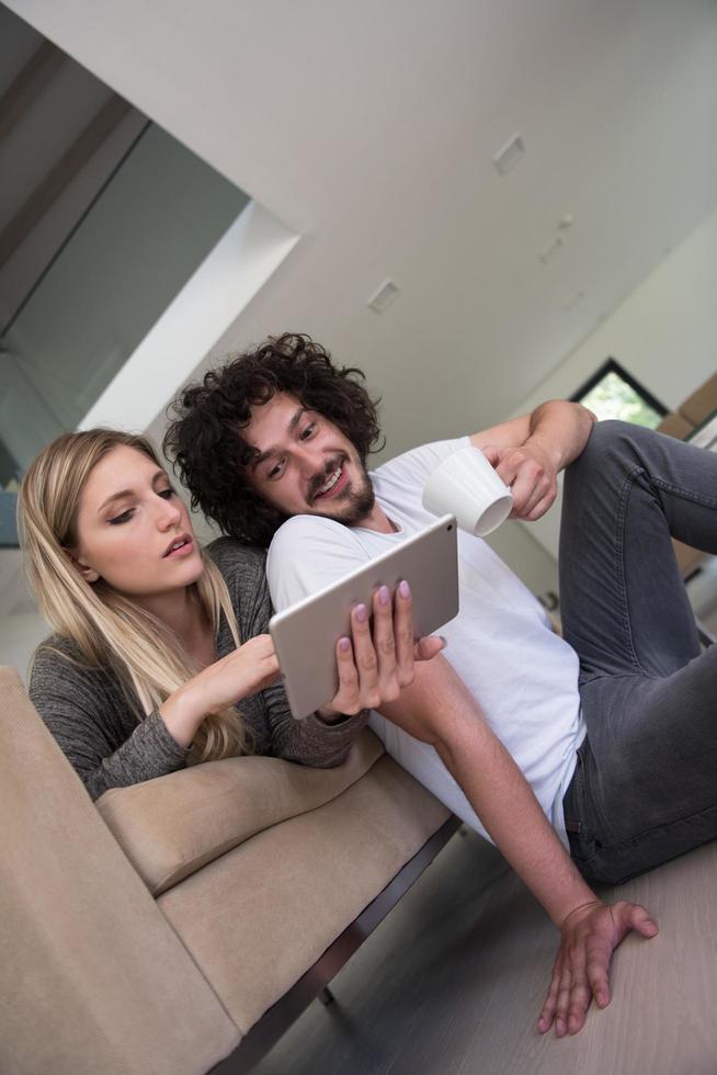 couple relaxing at  home with tablet computers photo