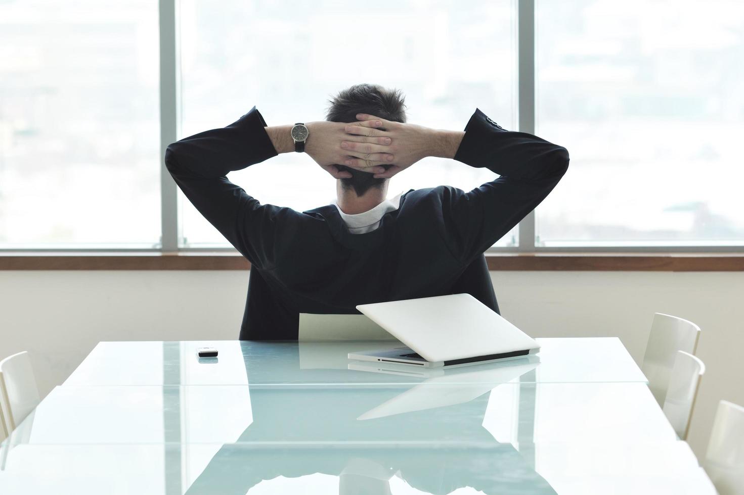 young business man alone in conference room photo