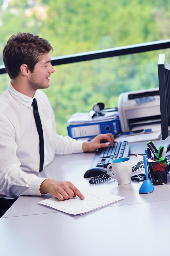happy young business man at office photo
