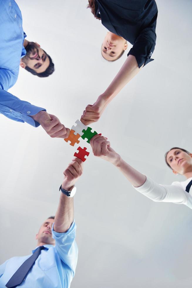 Group of business people assembling jigsaw puzzle photo