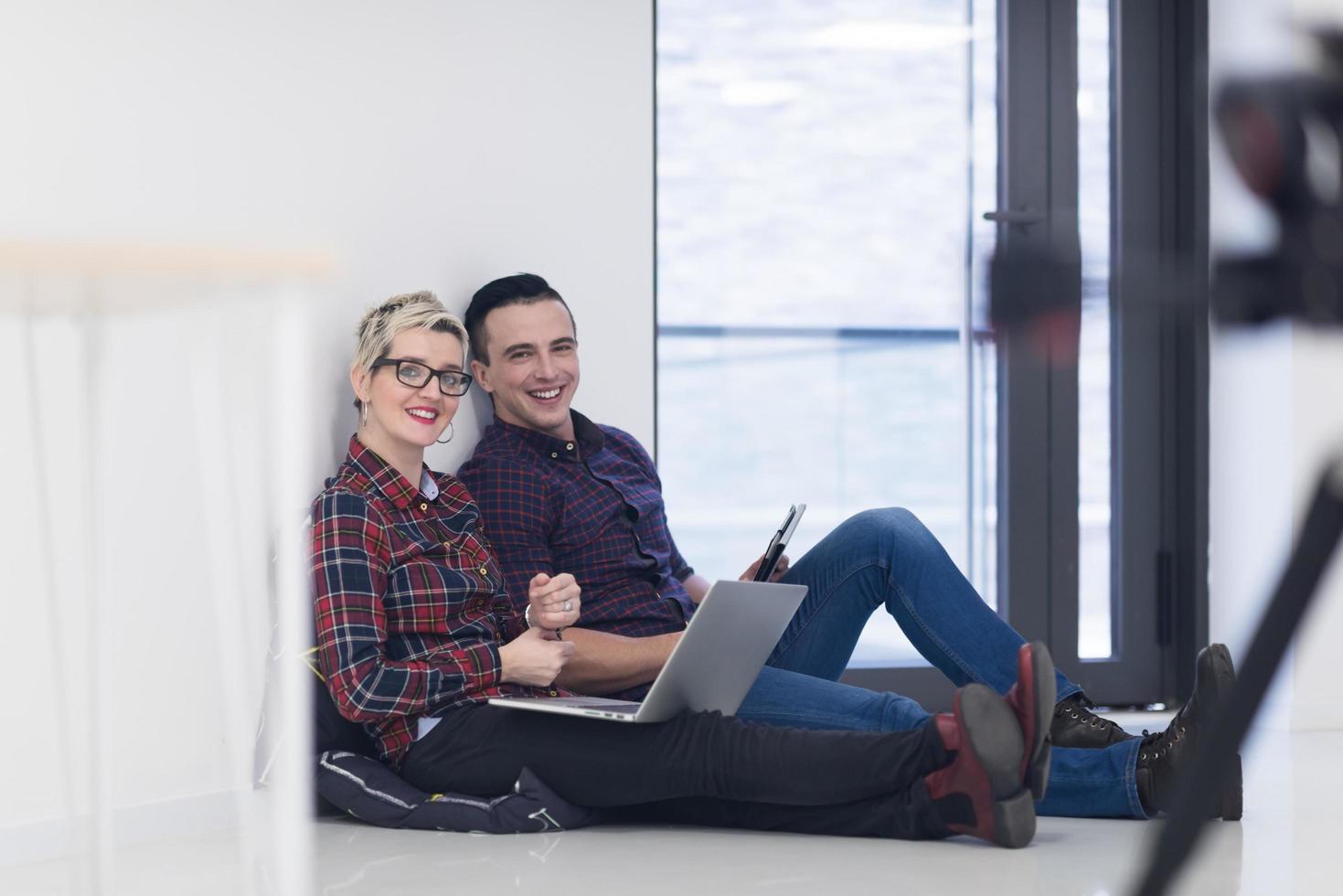 startup business, couple working on laptop computer at office photo