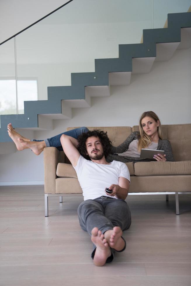 young couple relaxes in the living room photo