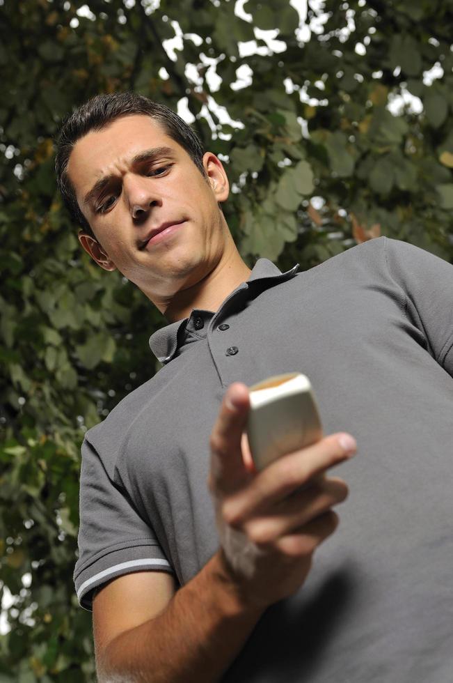 young casual man talking on cellphone photo