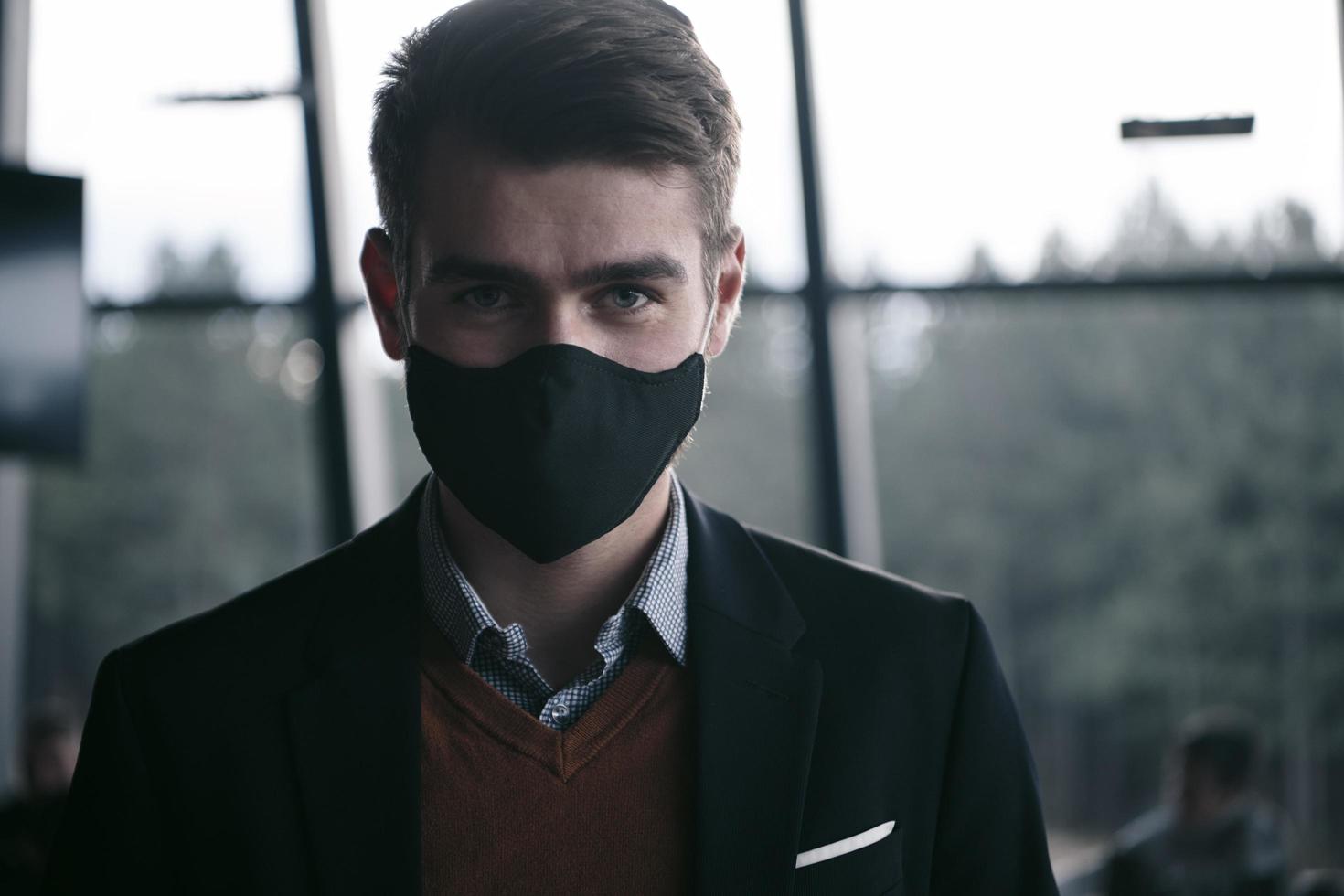 business man wearing protective face mask at luxury office photo