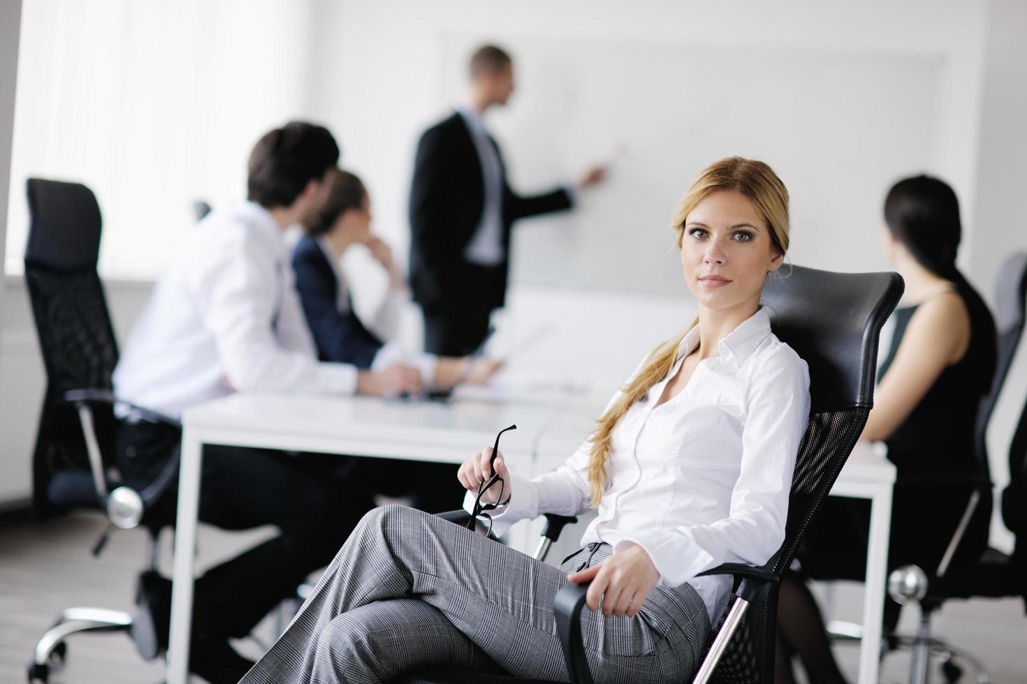 business woman with her staff in background photo