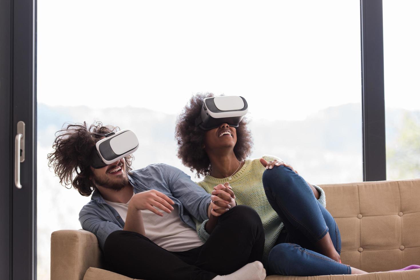 Multiethnic Couple using virtual reality headset photo