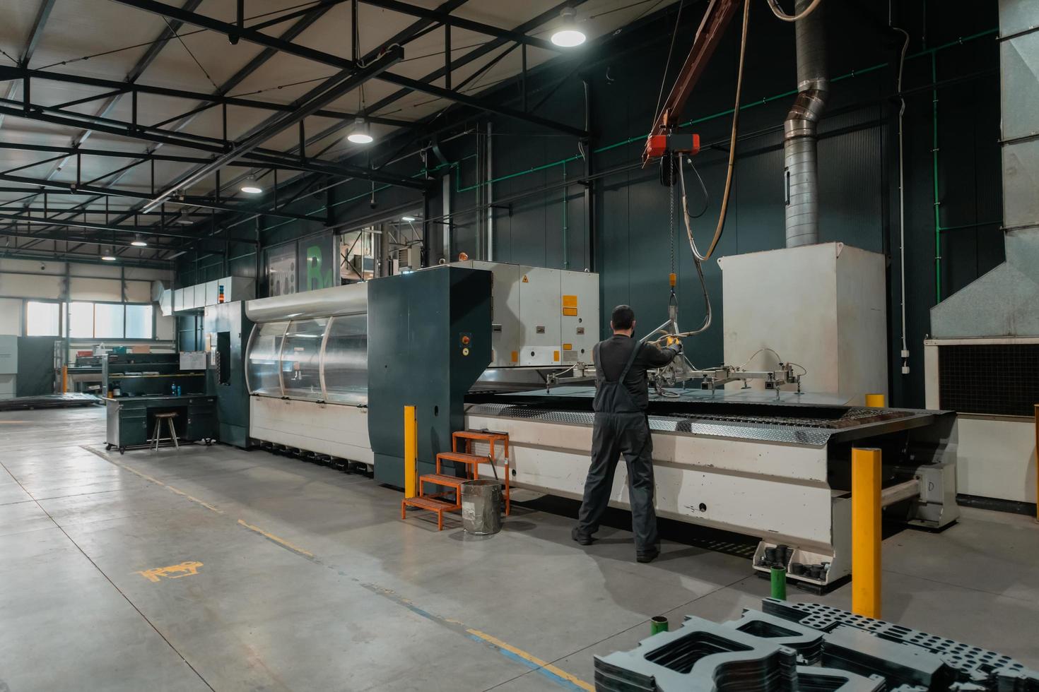 Turkey, 2022 - A smart factory worker or engineer wearing a face mask because of a pandemic and makes machines in a production workshop. The concept of industry and engineering. photo