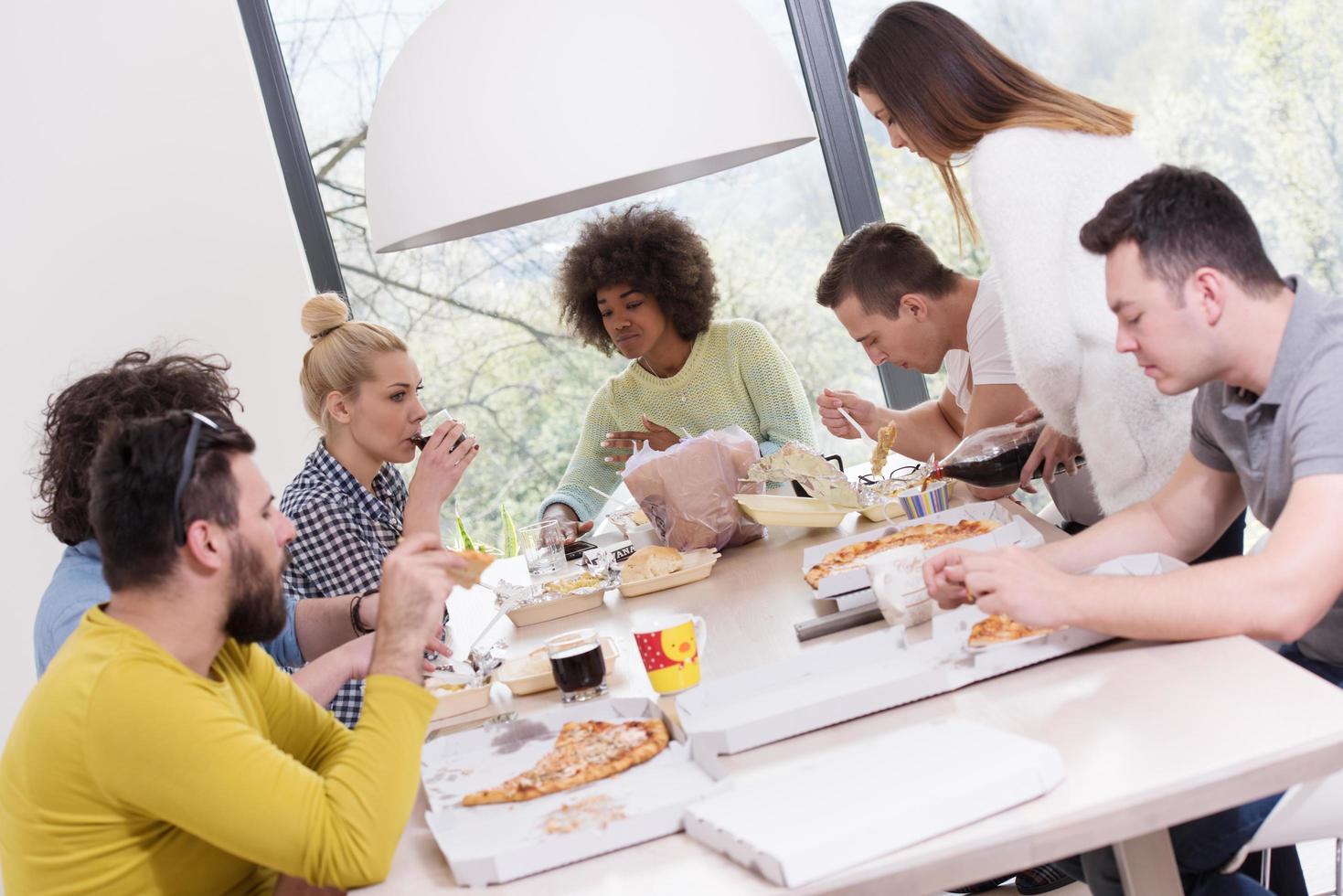 multiethnic group of happy friends lunch time photo