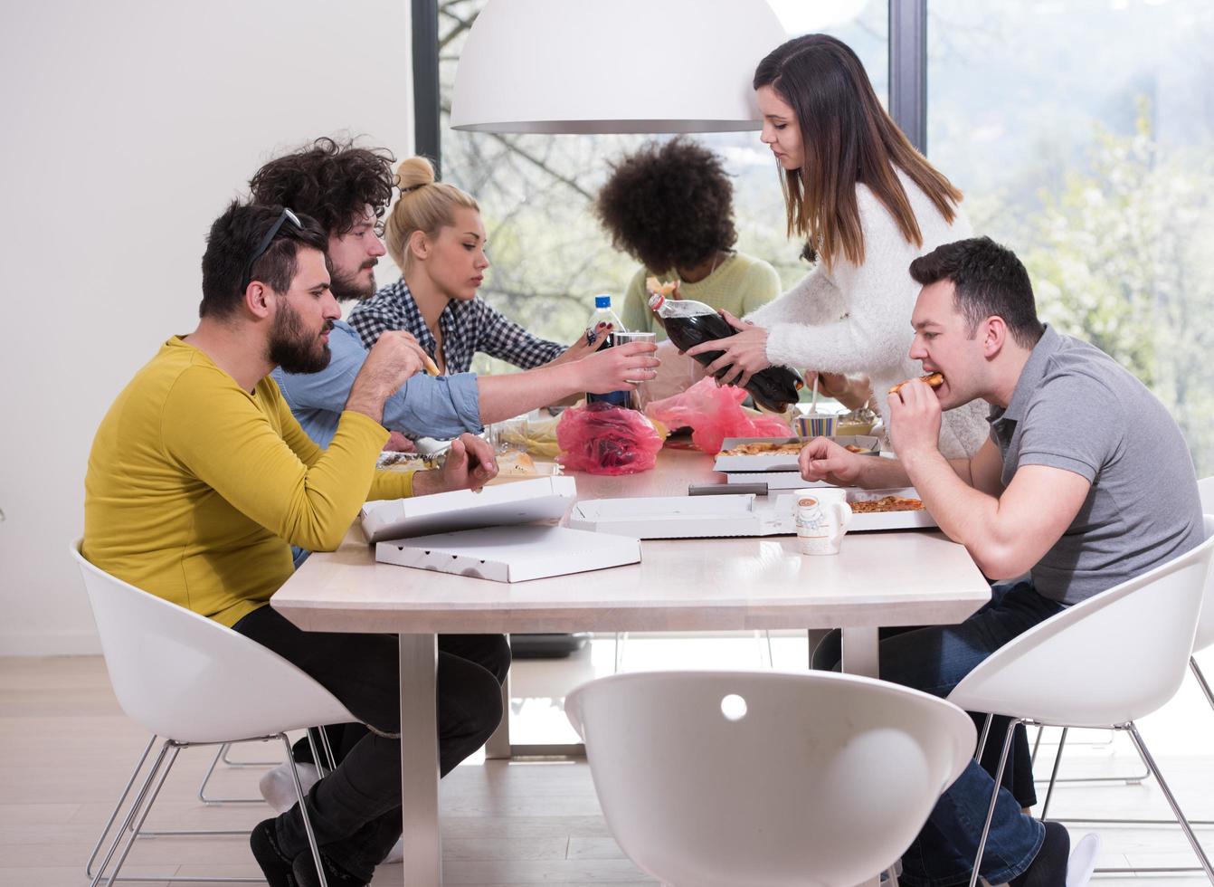 multiethnic group of happy friends lunch time photo