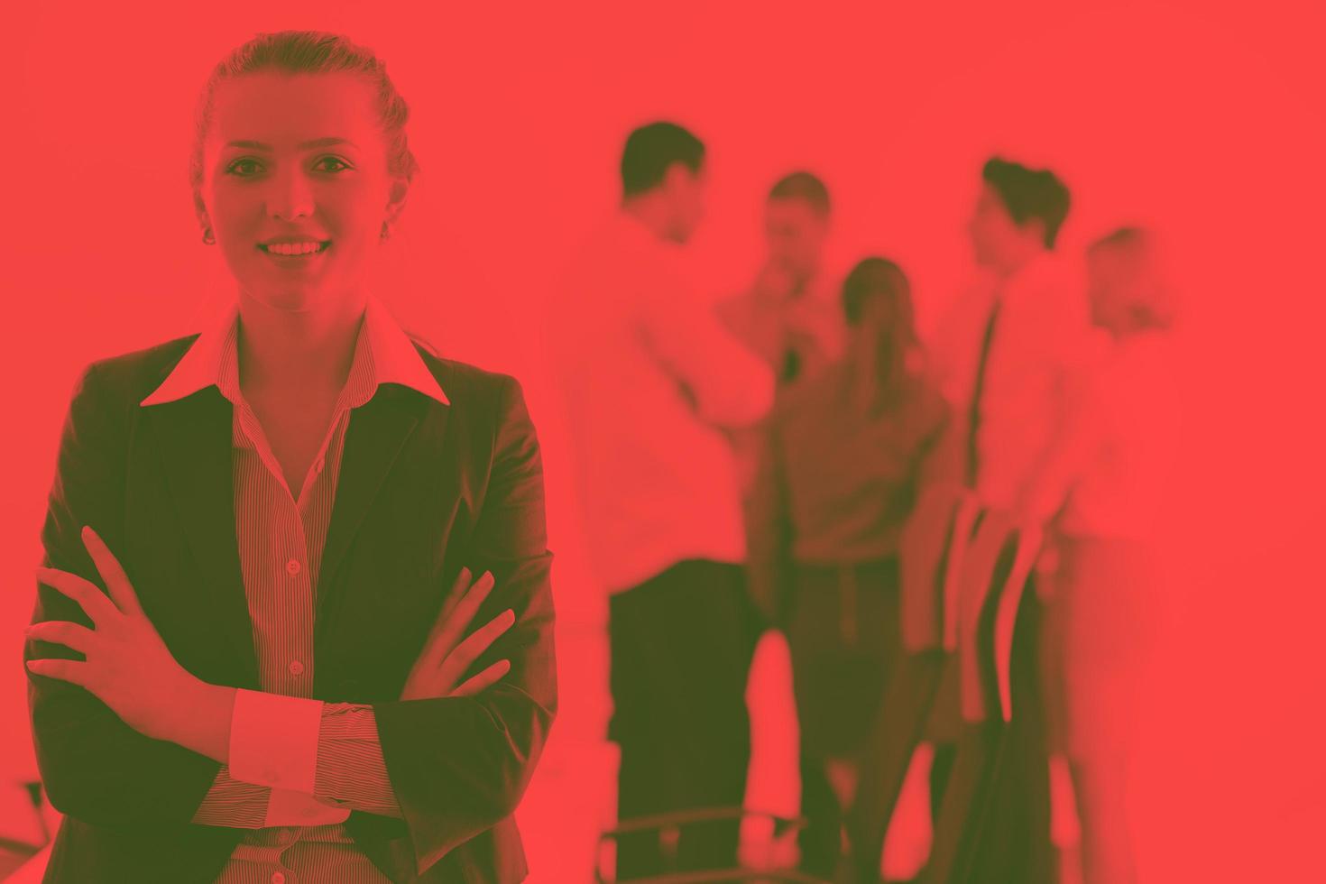 business woman standing with her staff in background photo