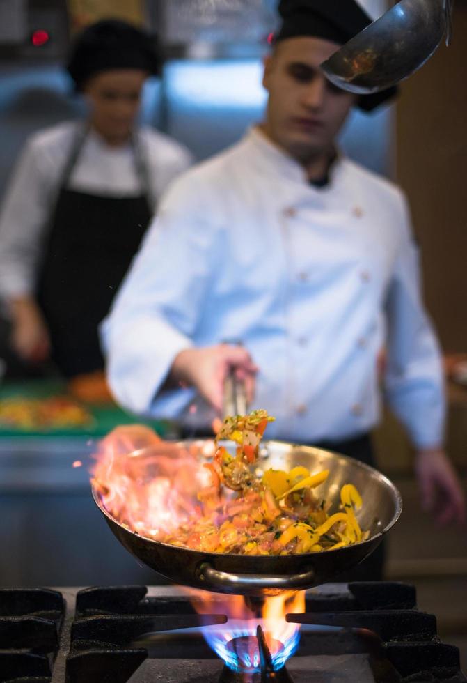 Chef doing flambe on food photo
