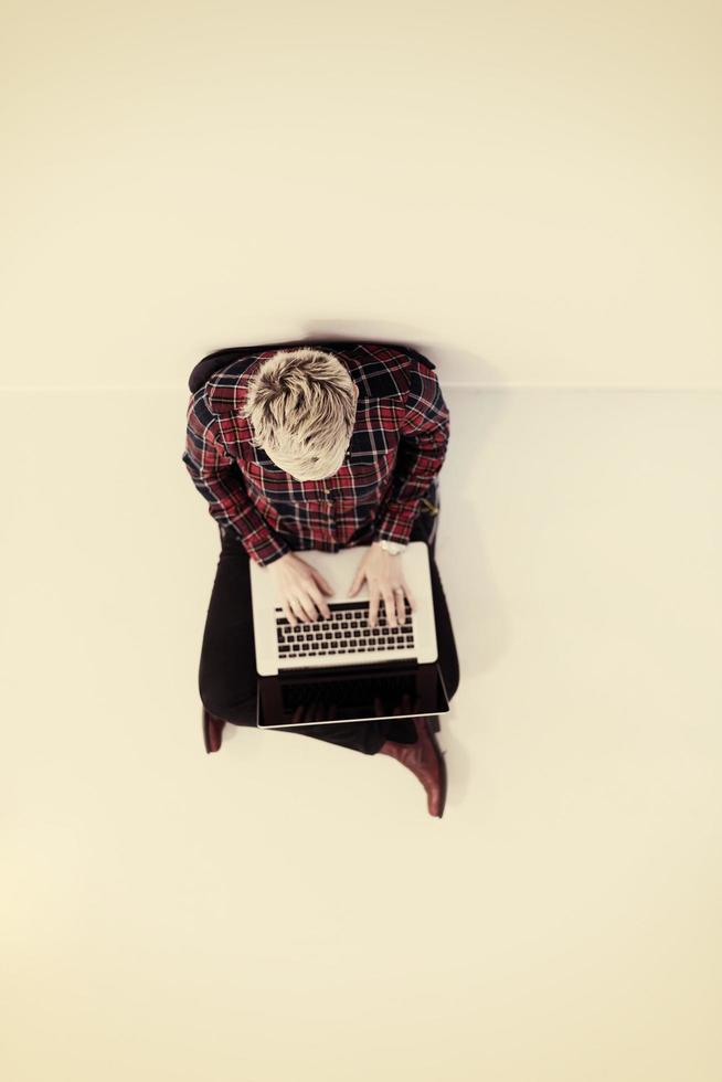 top view of young business woman working on laptop computer photo