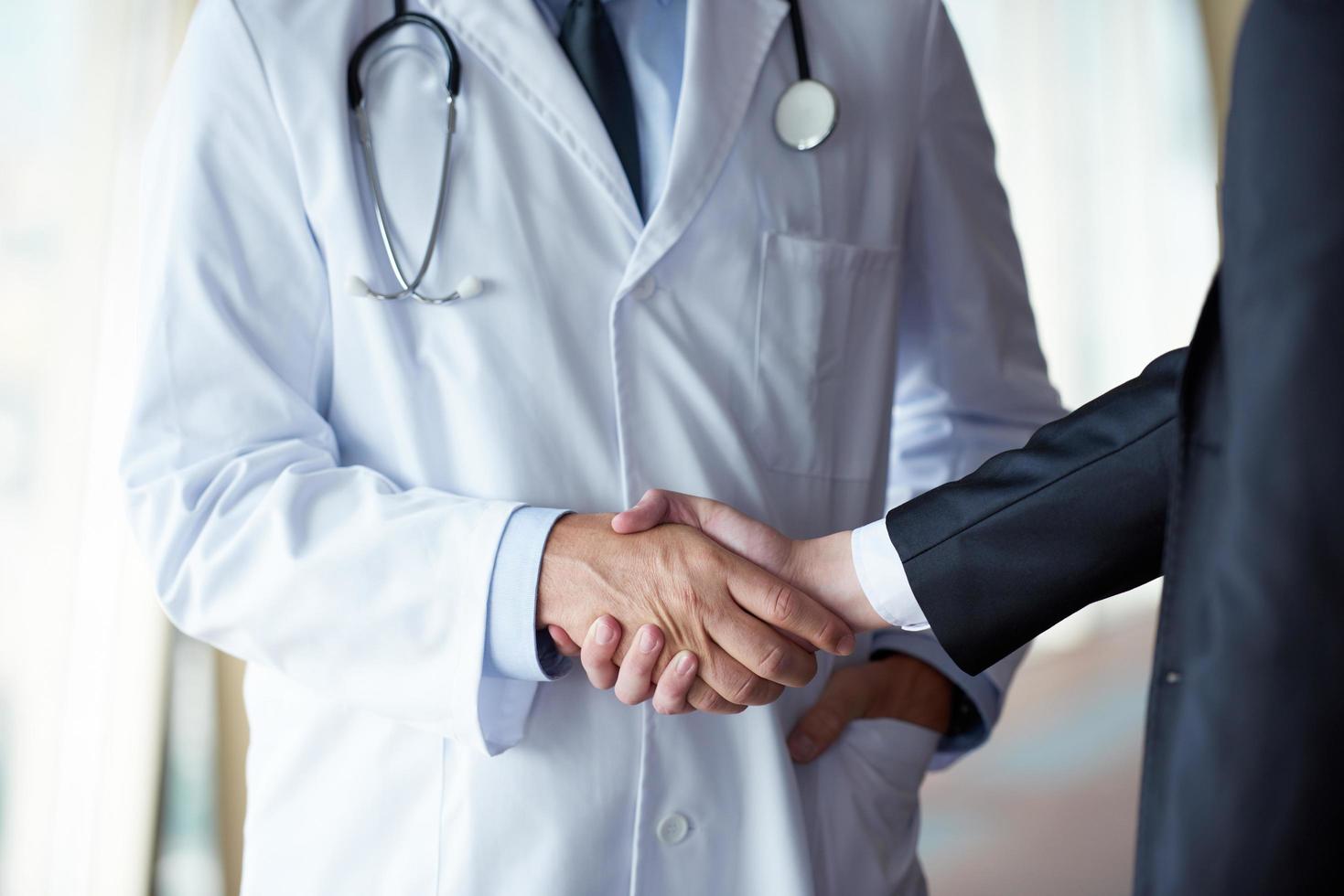 doctor handshake with a patient photo