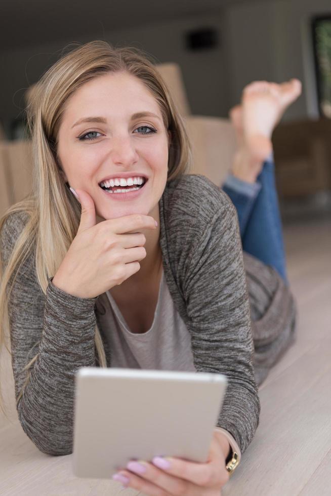 young women used tablet computer on the floor photo