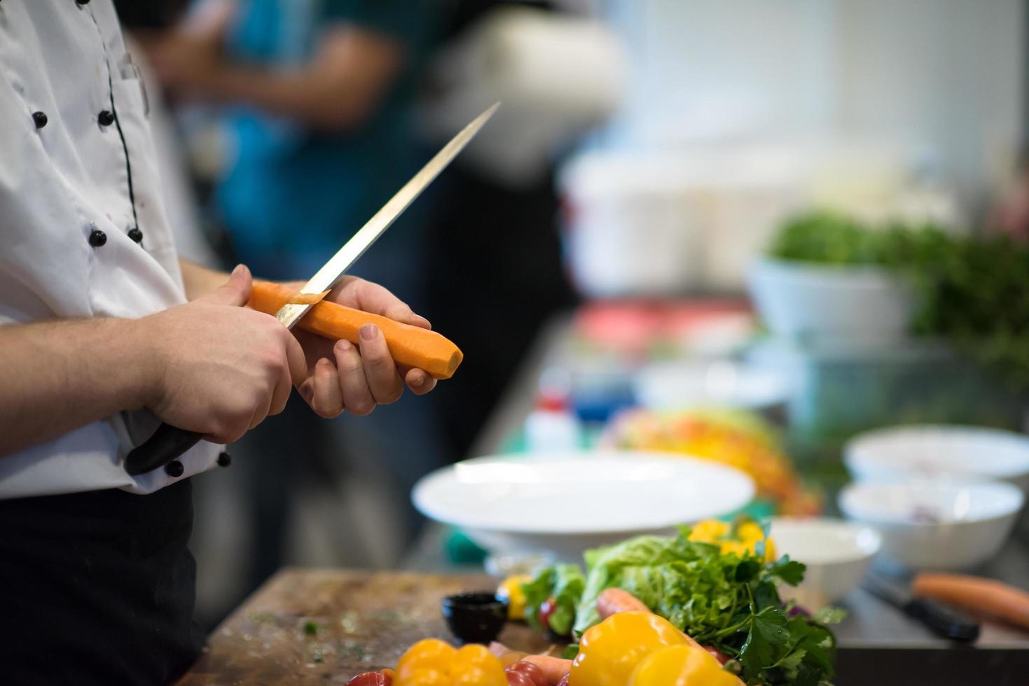 chef hands cutting carrots photo