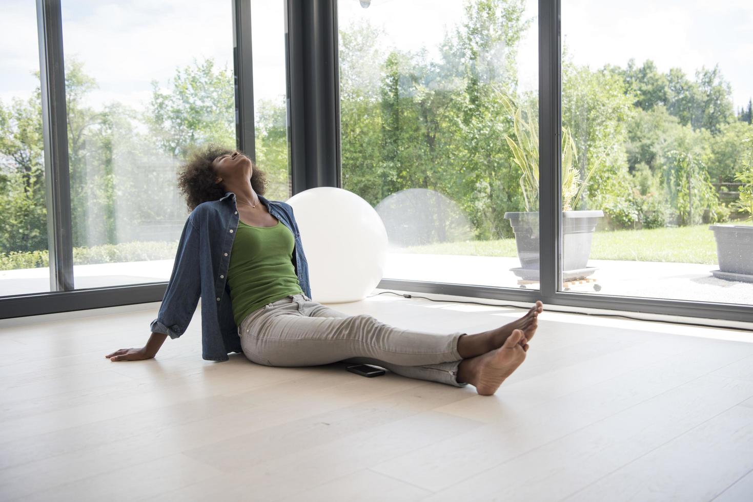 african american  woman  sitting near window photo