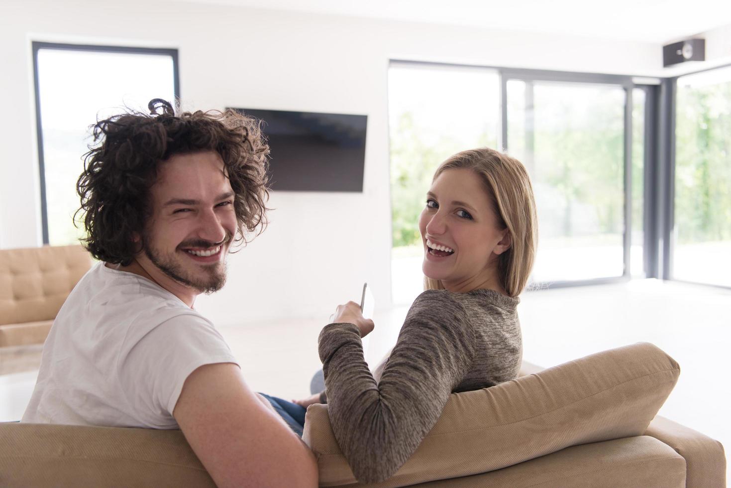 Rear view of couple watching television photo