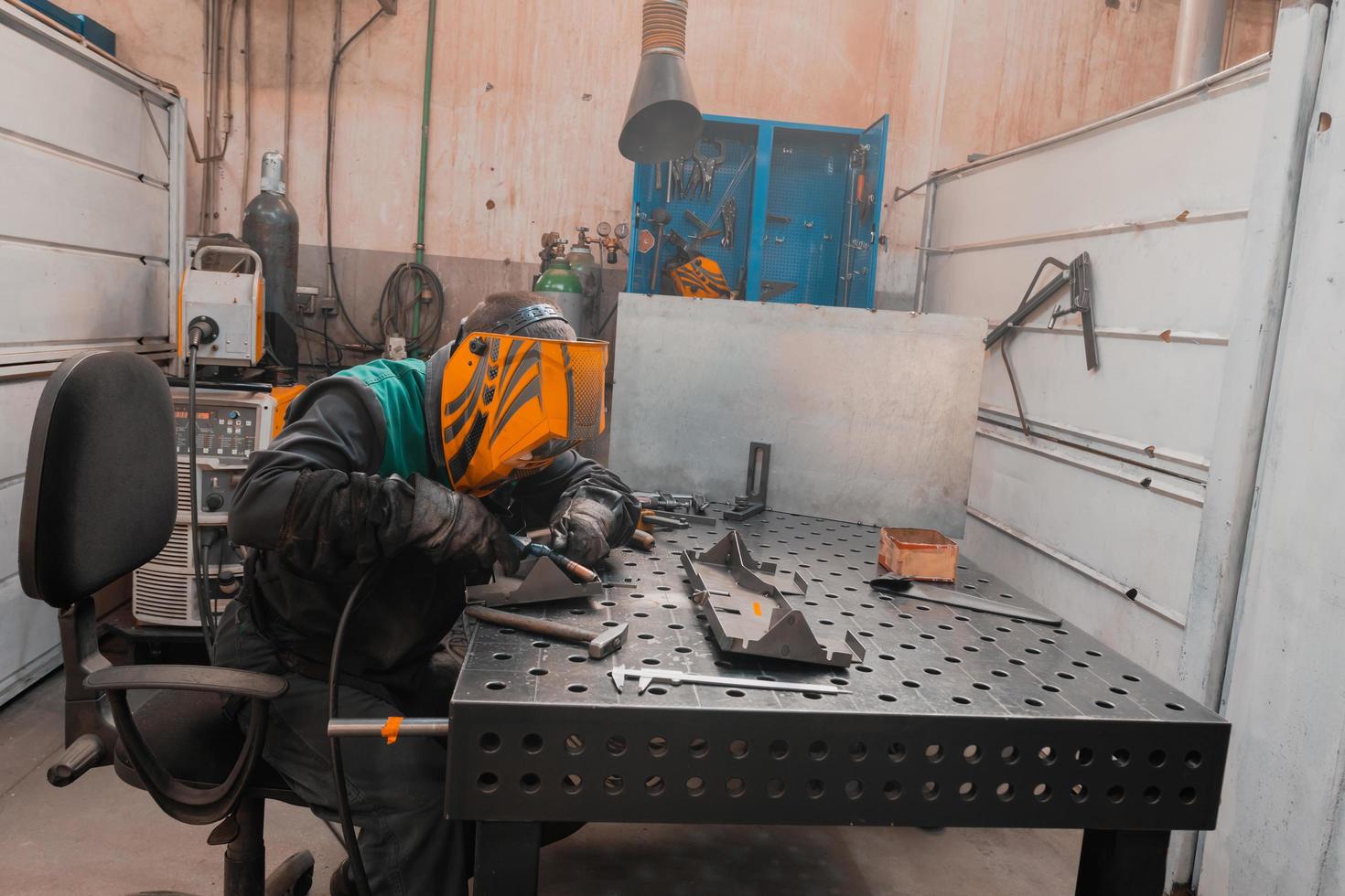 Professional welder performs work with metal parts in factory, sparks and electricity. Industry worker banner. photo