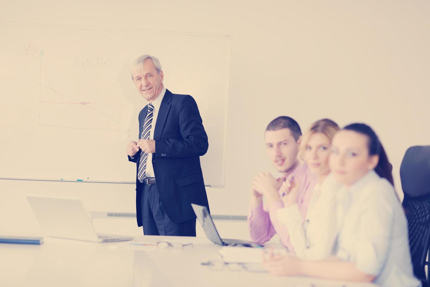 Senior business man giving a presentation photo