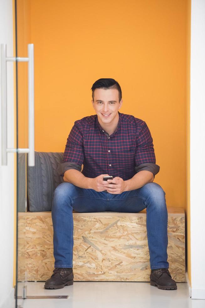 man in crative box working on smart phone photo