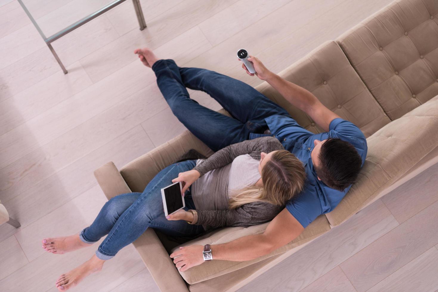 youg couple in living room with tablet top view photo