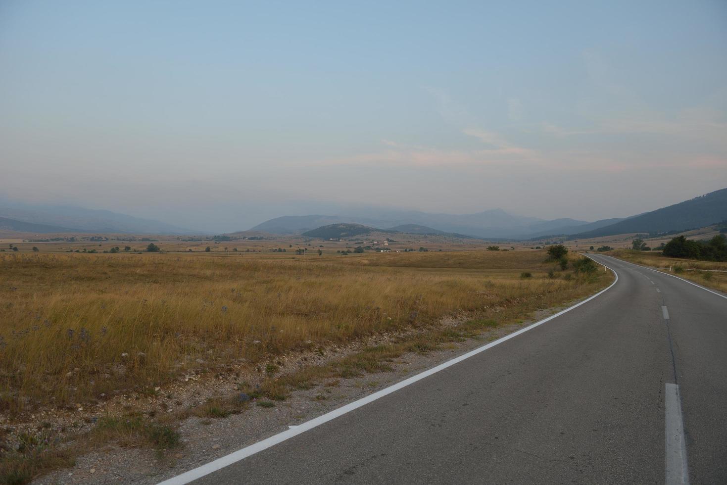 road through the green field photo