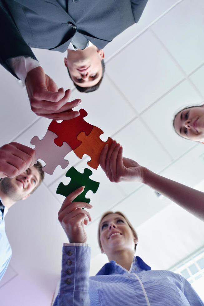 Group of business people assembling jigsaw puzzle photo