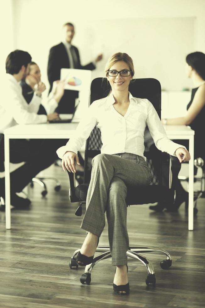 business woman with her staff in background photo