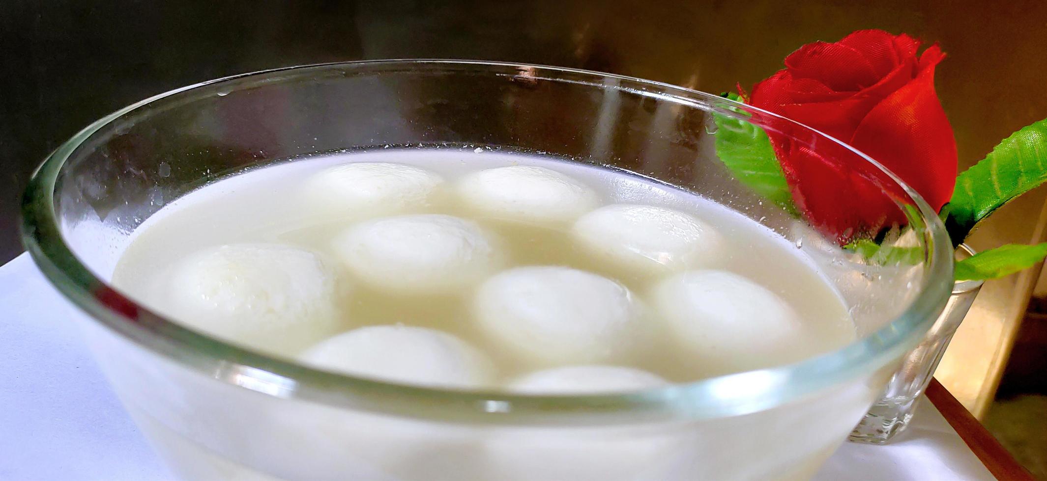 Indian Rasgulla or Rosogulla dessert sweet served in a bowl photo
