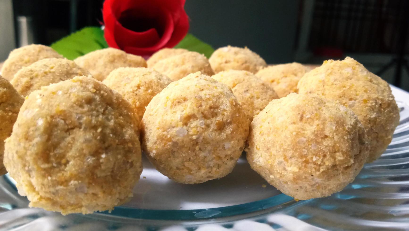 Mouth watering sweet - Besan laddoo made by roasted gram flour, ghee, dry fruits and sugar, served in a plate photo