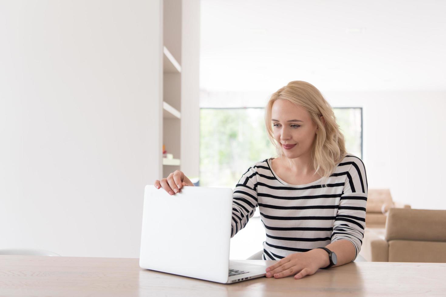 Young woman with laptop at home photo