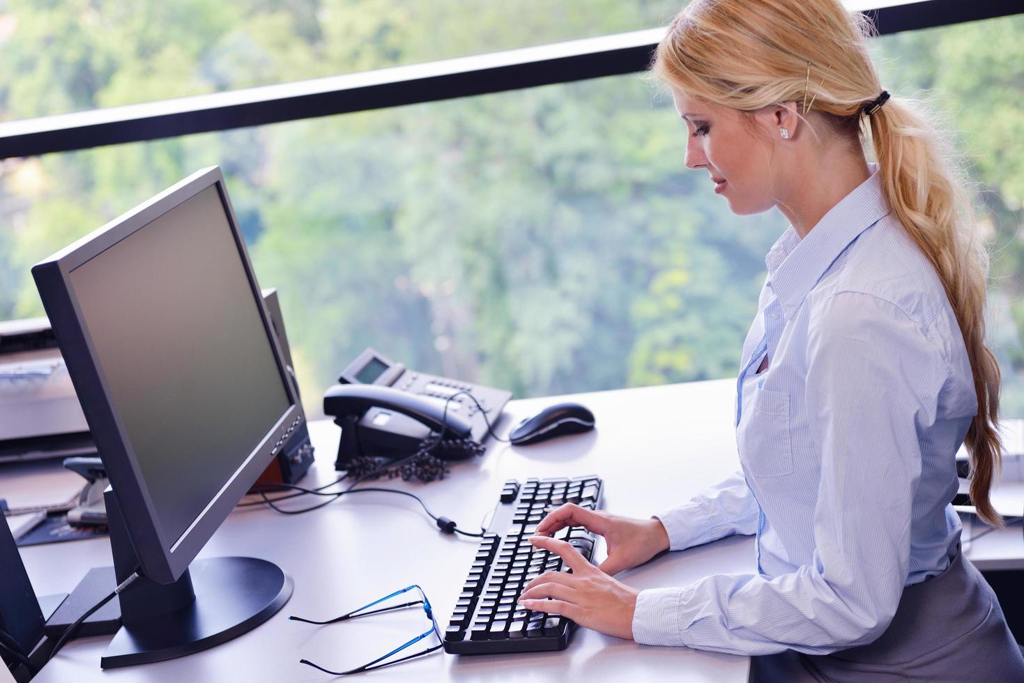 business woman working on her desk in an office photo