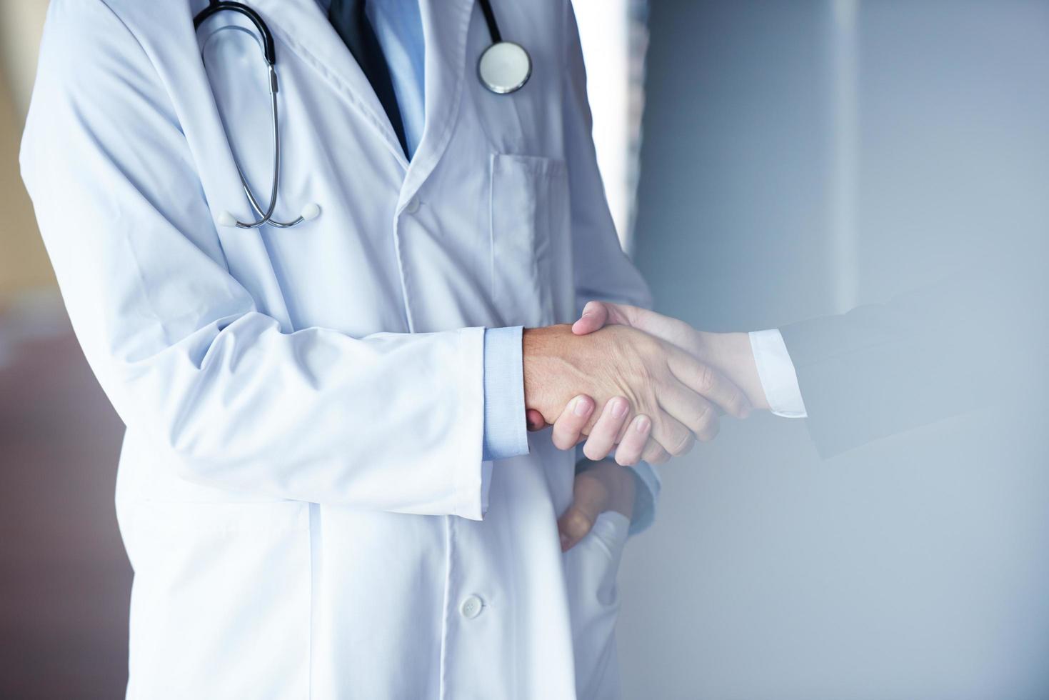 doctor handshake with a patient photo