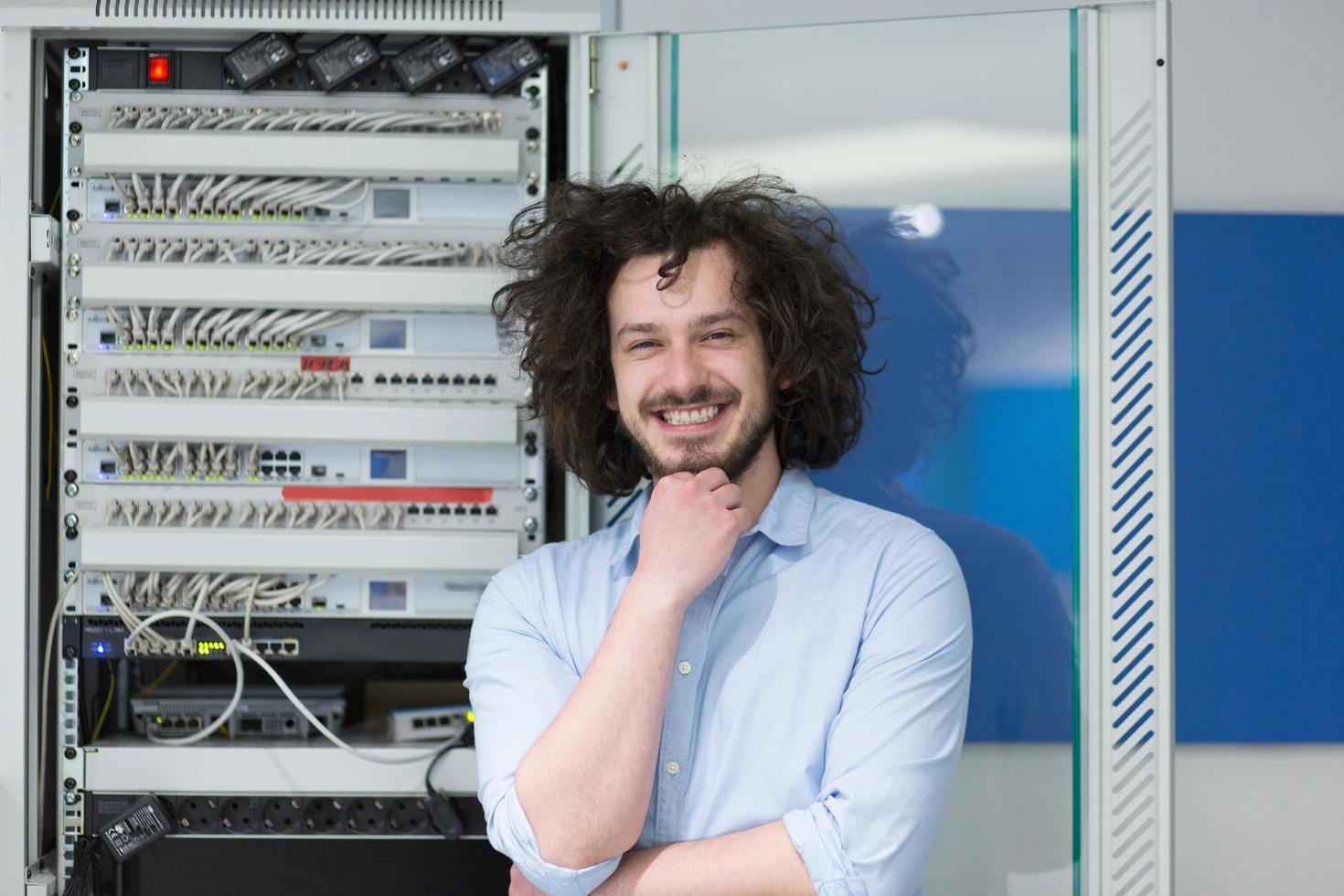 business man engeneer in datacenter server room photo