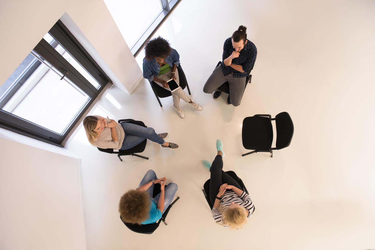 Multiethnic startup business team on meeting  top view photo