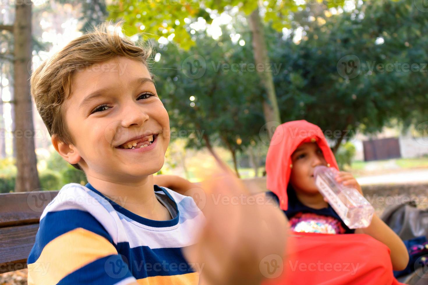 Cute happy boy enjoying while relaxing at the park. photo