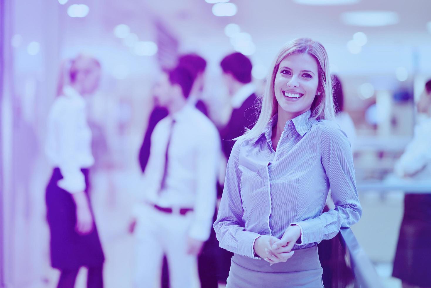 business woman with her staff in background at office photo