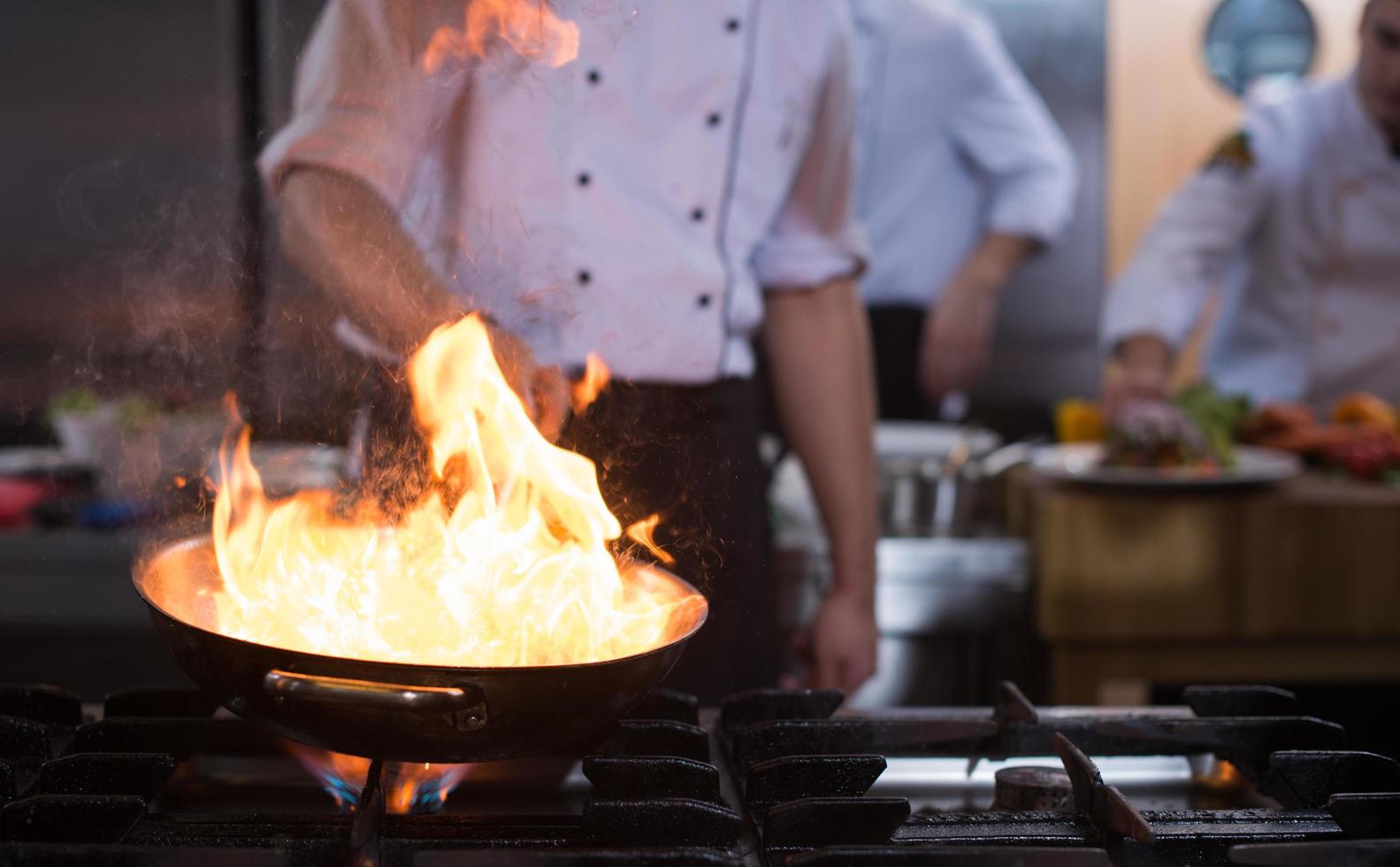 Chef doing flambe on food photo