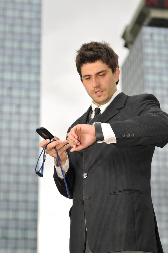 Photo of happy winner businessman  talking on mobile phone
