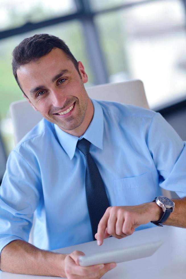 business man using tablet compuer at office photo