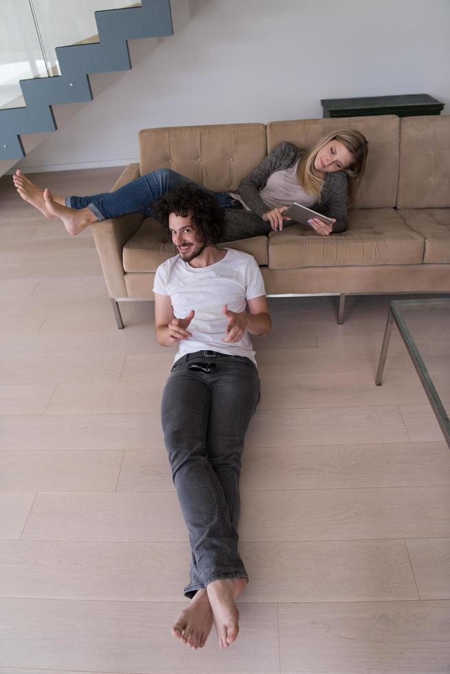 young couple relaxes in the living room photo