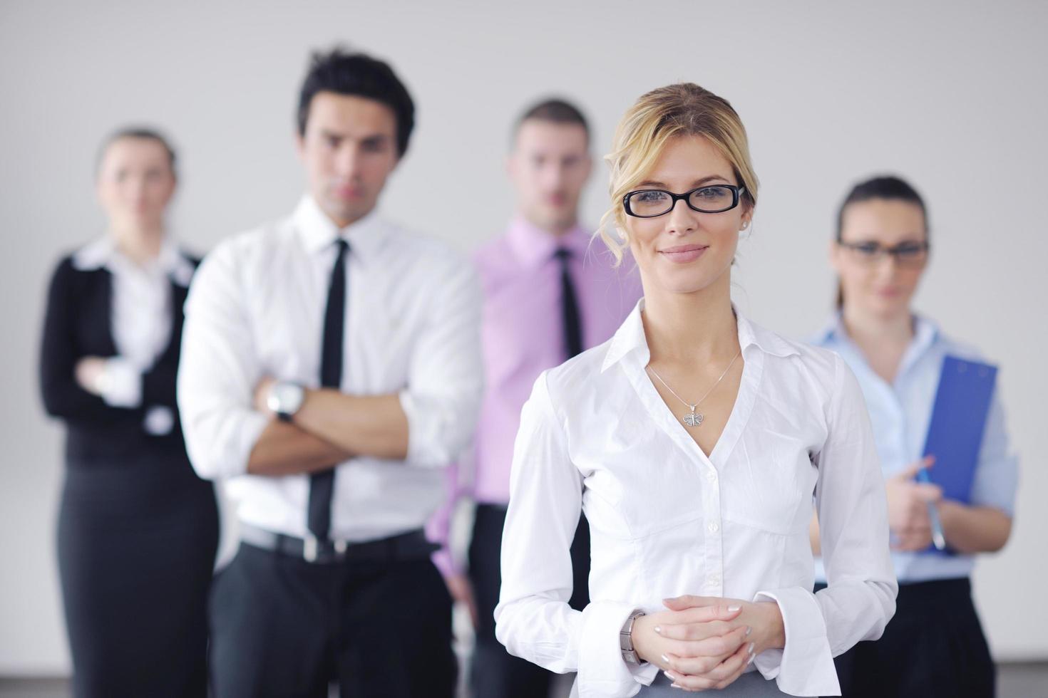 business woman standing with her staff in background photo