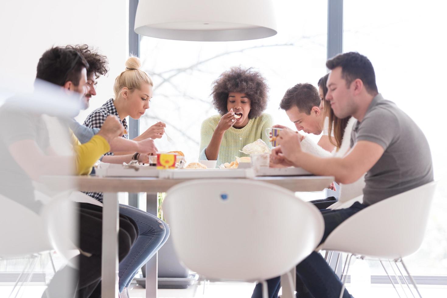 multiethnic group of happy friends lunch time photo