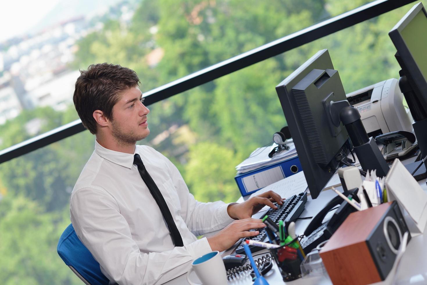 happy young business man at office photo