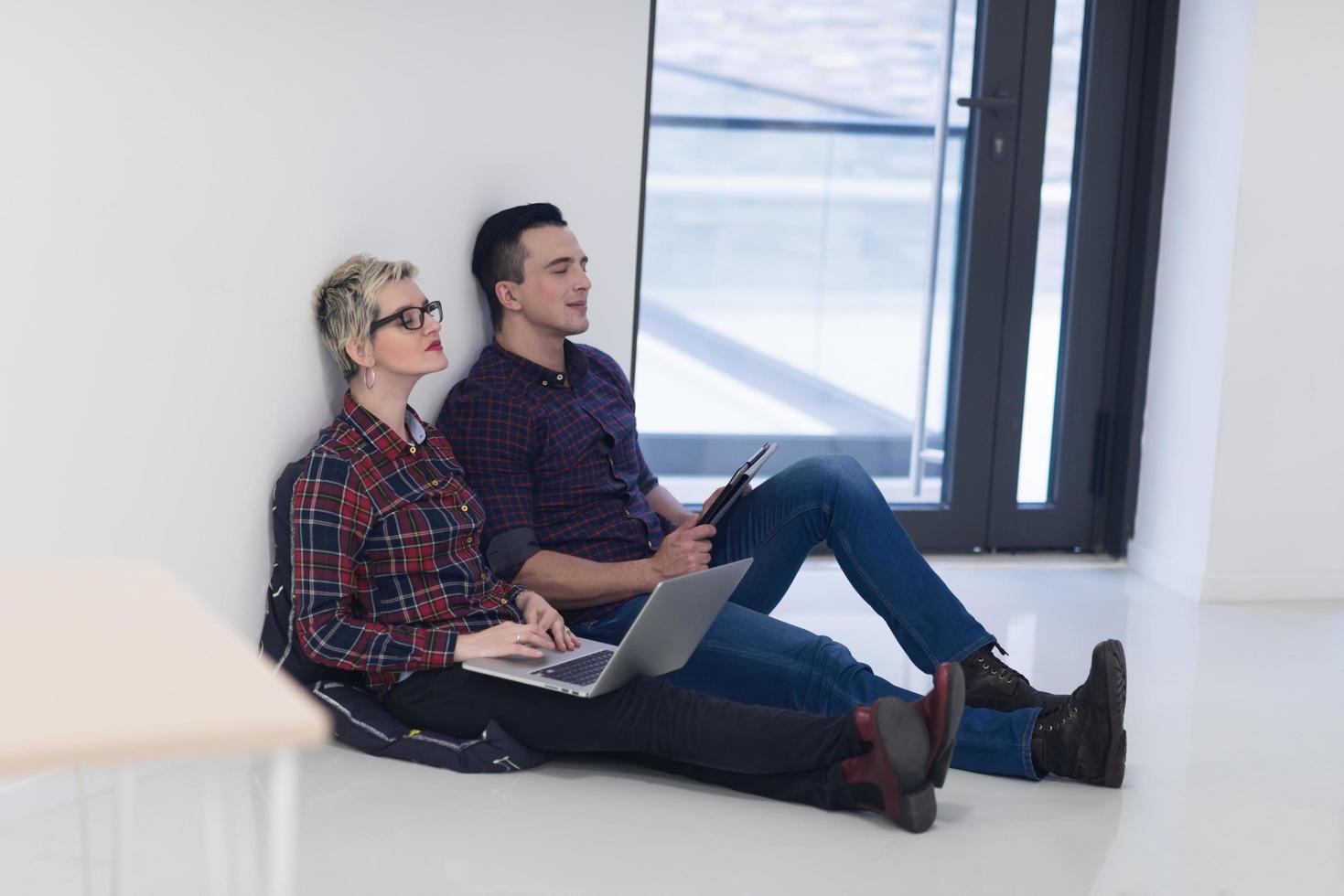 startup business, couple working on laptop computer at office photo