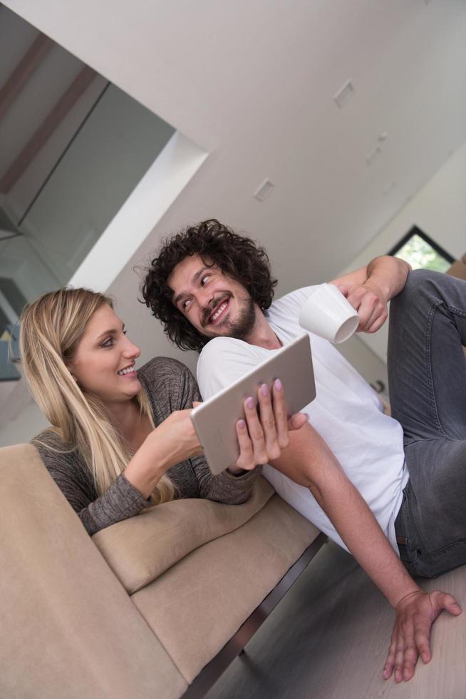 couple relaxing at  home with tablet computers photo
